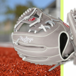 A Rawlings R9 softball glove near a ball