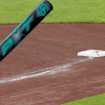 A Louisville Slugger PXT bat near first base