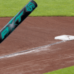 part time travel softball teams A Louisville Slugger PXT bat near first base